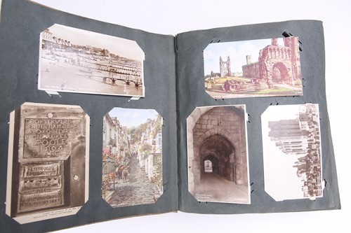 Lot 197 - A vintage postcard album containing many...