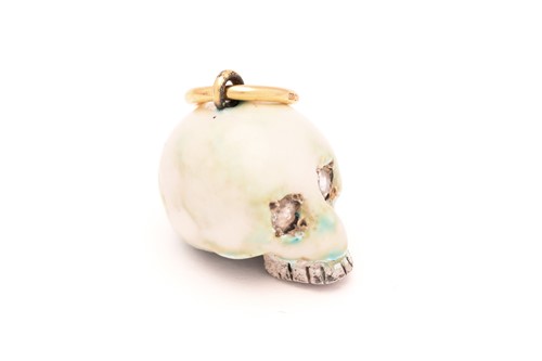 Lot 54 - An enamel skull charm pendant with diamonds, a...