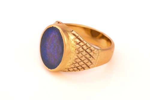 Lot 307 - A black opal signet ring, featuring an oval...