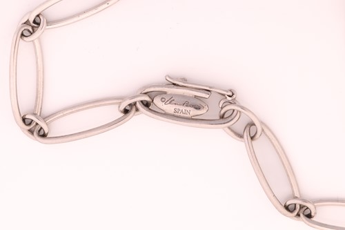 Lot 13 - Tiffany & Co. - A platinum charm bracelet with...