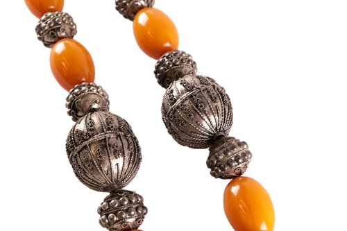 Lot 105 - A large Yemeni silver metal and amber necklace,...