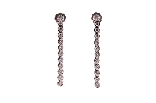 Lot 191 - A pair of diamond line drop earrings, each has...