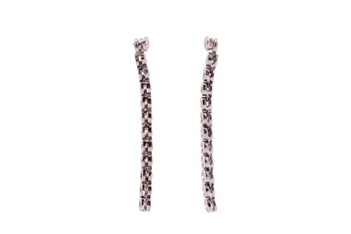 Lot 31 - A pair of diamond line drop earrings, each has...