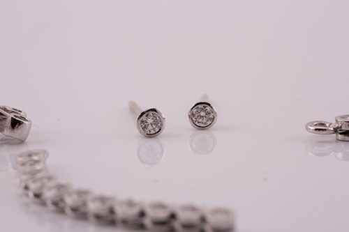 Lot 31 - A pair of diamond line drop earrings, each has...