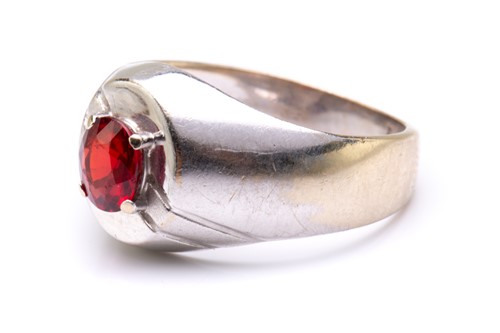 Lot 22 - A signet ring set with synthetic ruby,...