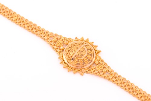 Lot 10 - A filigree bracelet; the central roundel, with...
