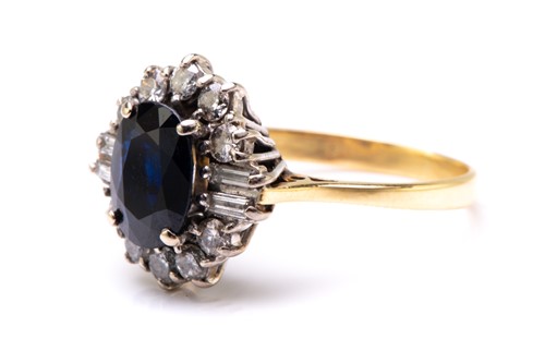 Lot 33 - A sapphire and diamond cluster ring in 18ct...
