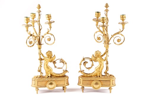 Lot 293 - A pair of Louis XVI style ormolu three-sconce...