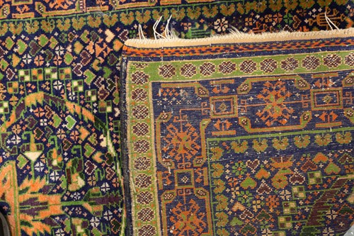 Lot A 20th-century cupric green ground Kazak rug...