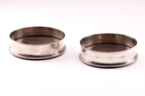 Lot 309 - A pair of modern silver bottle coasters with...