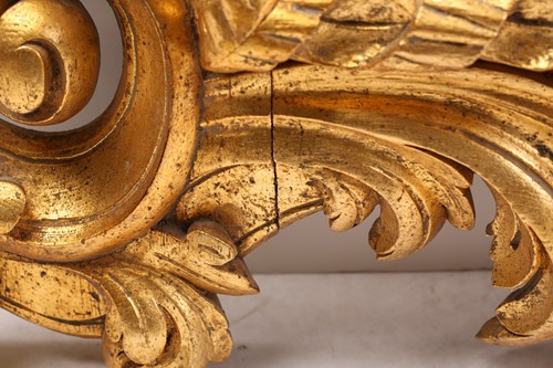 Lot 264 - A carved and gilt rococo style wall mirror,...