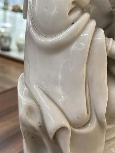 Lot 134 - A Chinese Dehua blanc de chine figure of...