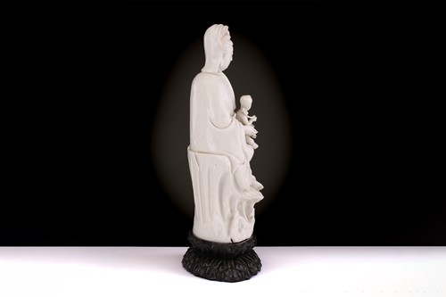 Lot 134 - A Chinese Dehua blanc de chine figure of...