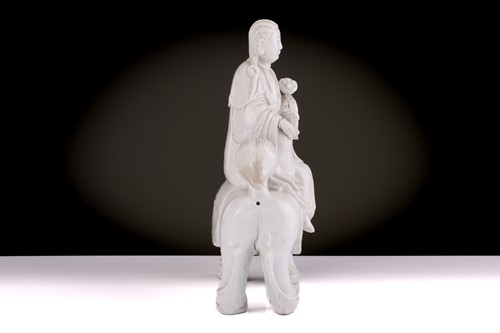 Lot 207 - A Chinese Dehua blanc de chine figure of...