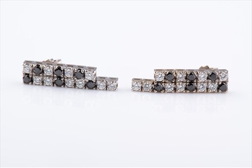 Lot 452 - A pair of black and white diamond earrings the...