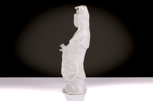 Lot 138 - A Chinese Dehua blanc de chine standing figure...