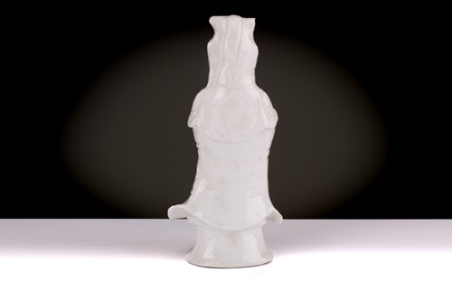 Lot 138 - A Chinese Dehua blanc de chine standing figure...