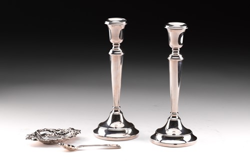 Lot 300 - A pair of silver candlesticks of plan form...