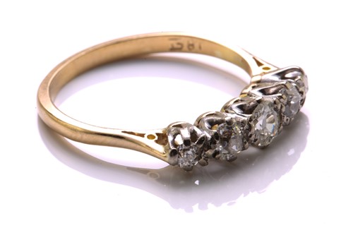 Lot 81 - A five-stone diamond half hoop ring, comprises...