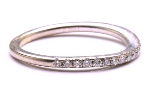 Lot 23 - A diamond-set half eternity ring, consisting...
