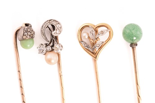 Lot 27 - Four gem-set stick pins; A heart-shaped stick...