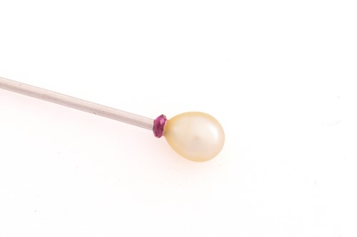 Lot 164 - A pearl stick pin, the egg-shaped pearl has...