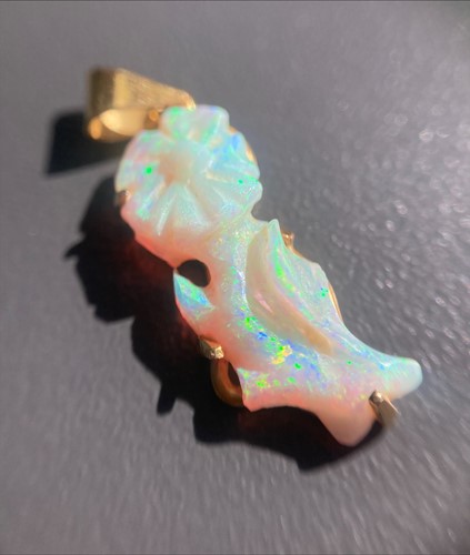 Lot 74 - A carved opal pendant, comprises precious opal...