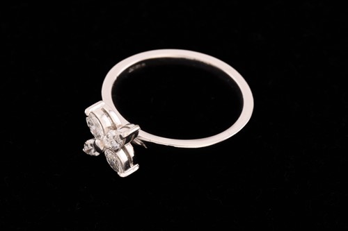 Lot 127 - A four-stone diamond petal ring, consisting of...