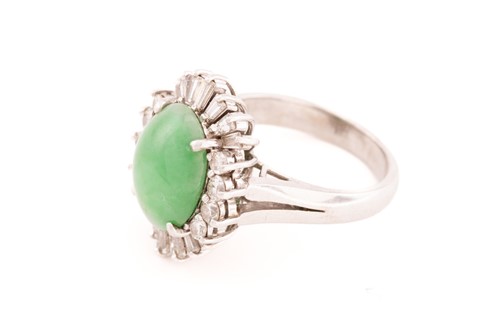 Lot 168 - A jade and diamond entourage ring, consisting...