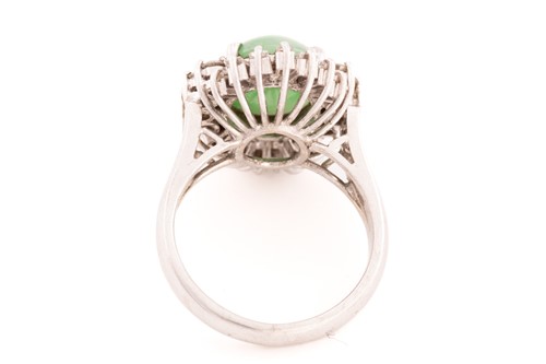 Lot 168 - A jade and diamond entourage ring, consisting...