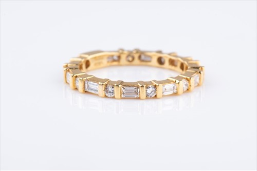 Lot 513 - An 18ct yellow gold and diamond eternity ring...