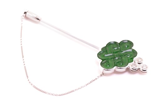 Lot 35 - A carved jade and diamond stick pin in the...