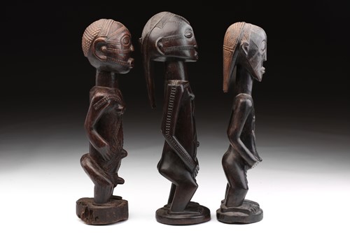 Lot 7 - Two Tabwa standing female figures and a male...