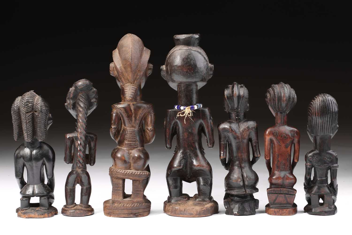 Lot 83 - A group of seven Baule fertility figures,