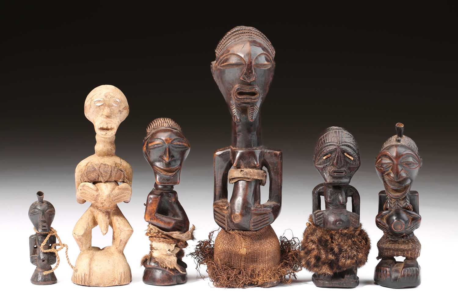 Lot 19 - A group of Songye power figures, Nikisi, and a...
