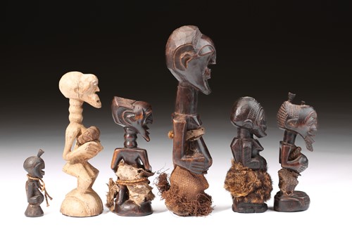 Lot 19 - A group of Songye power figures, Nikisi, and a...