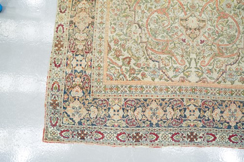 Lot 276 - An antique ivory ground Kirman rug with a...