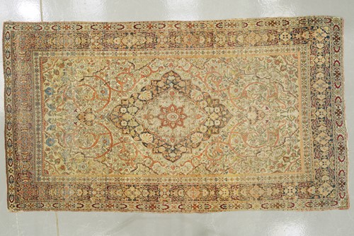 Lot 276 - An antique ivory ground Kirman rug with a...