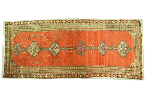 Lot 277 - An antique tomato red ground North Western...
