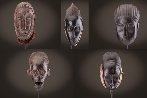 Lot 35 - Four Baule masks and a headress mask, Ivory...