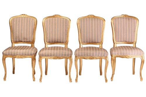 Lot 216 - A set of four Louis XV style carved and gilt...
