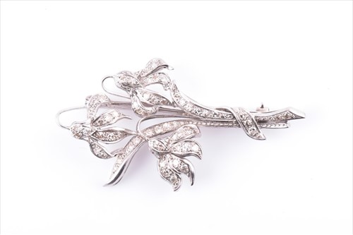 Lot 664 - A white metal and diamond brooch of floral...