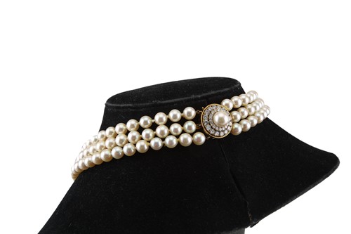 Lot 131 - A three-strand pearl necklace with 18ct gold...