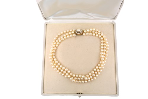 Lot 131 - A three-strand pearl necklace with 18ct gold...