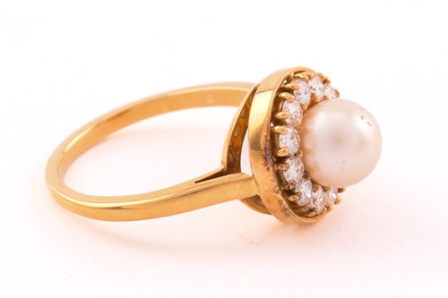 Lot 6 - A pearl and diamond entourage ring in 18ct...