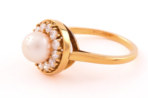 Lot 6 - A pearl and diamond entourage ring in 18ct...