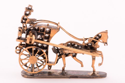 Lot 113 - A horse-drawn carriage brooch set with...