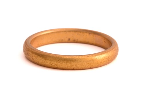 Lot 51 - A 22ct gold wedding band and three other rings;...