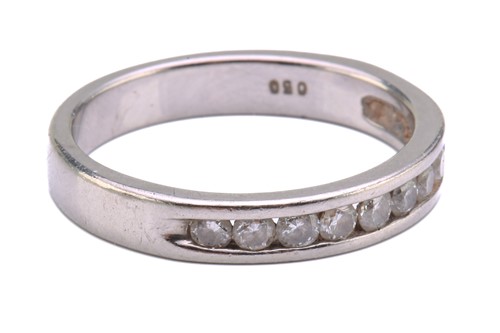 Lot 73 - A diamond half eternity ring in palladium,...
