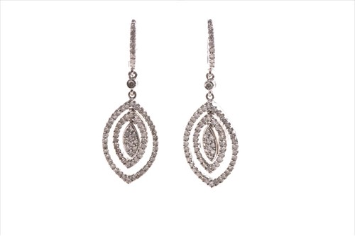 Lot 558 - A pair of white metal and diamond earrings of...